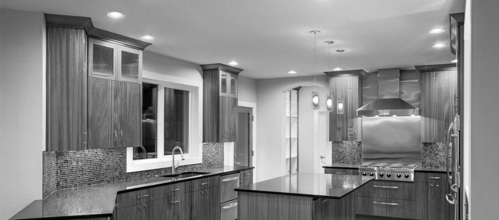 black and white slider of kitchen with granite countertop