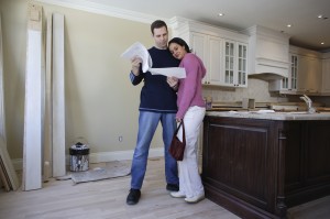 couple considering all the options of a home renovation including granite countertops