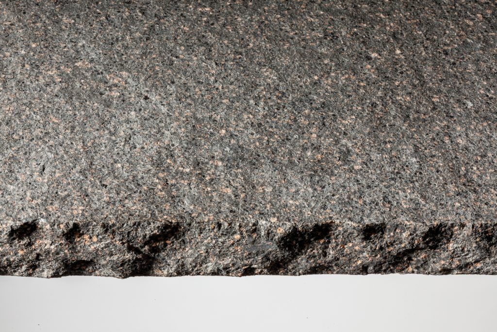 rough granite slab with coarse chiseled edge
