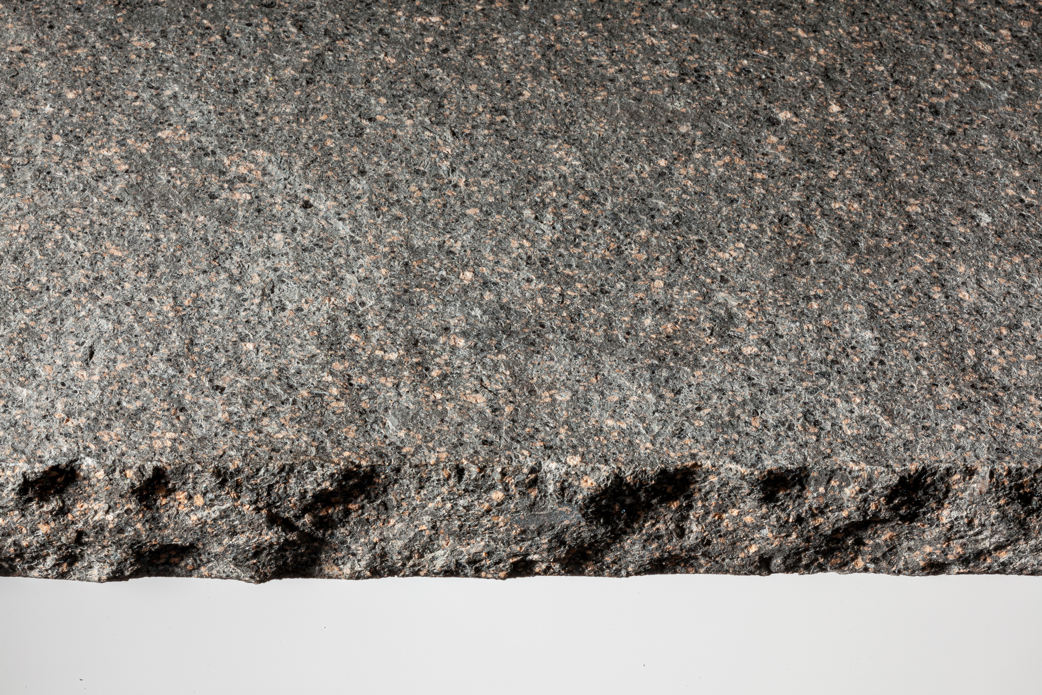 rough granite slab with coarse chiseled edge